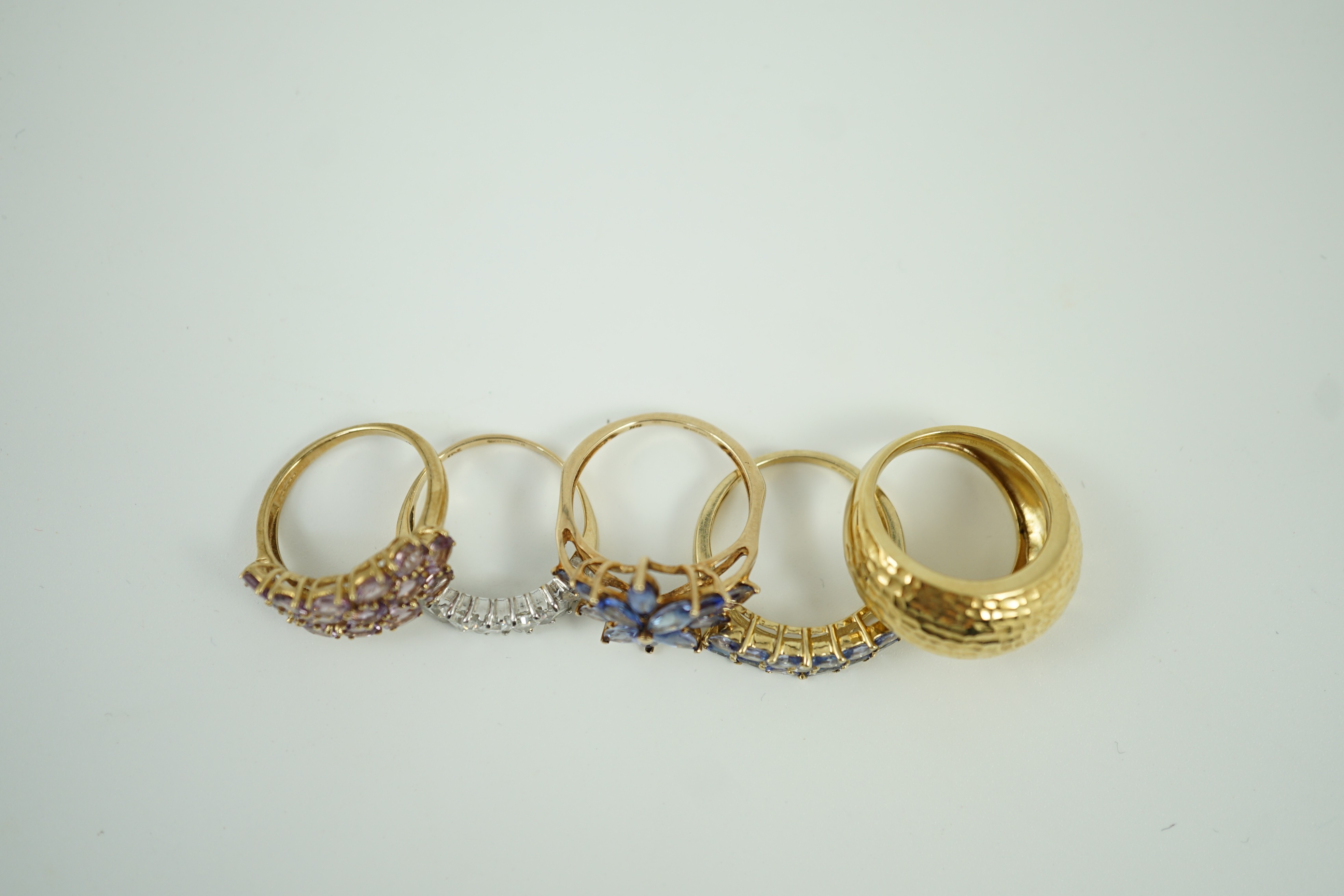 Four assorted modern 9ct gold and gem set rings and an Italian 375 ring, gross weight 14.4 grams.